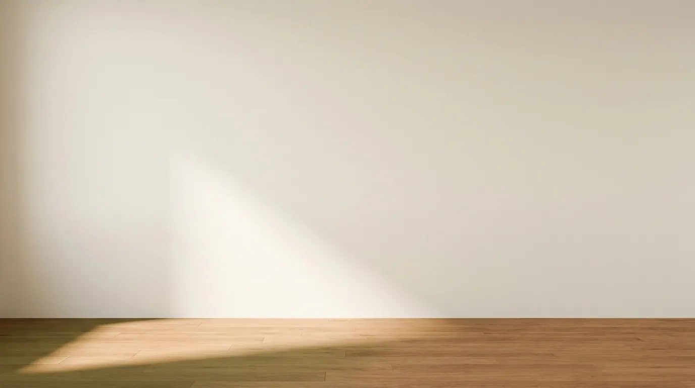 Empty cream room with soft overcast light across teak floor